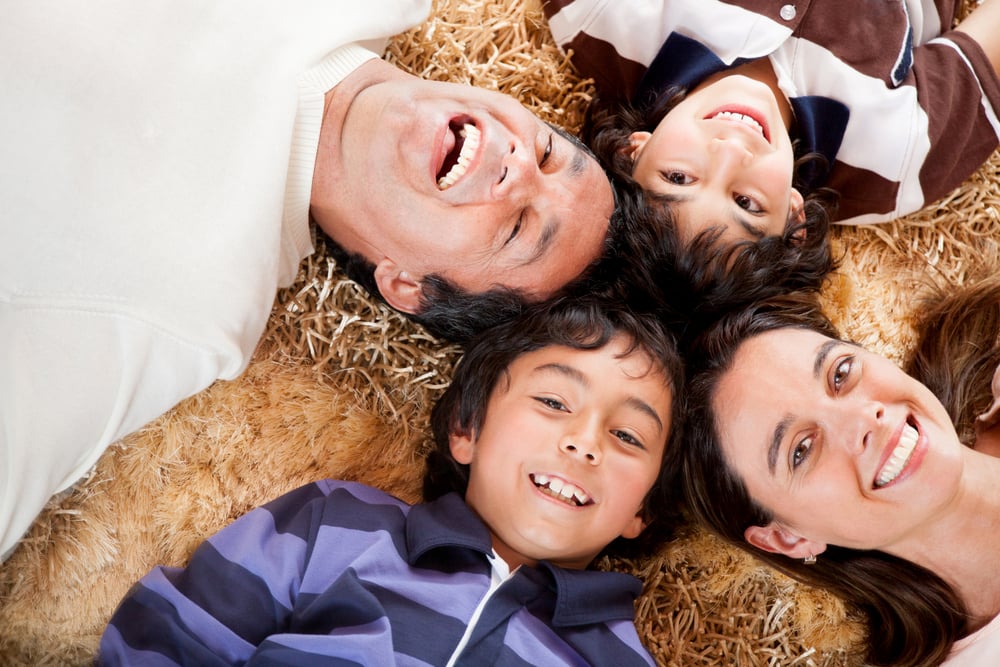 Happy family portrait laying on the carpet at home