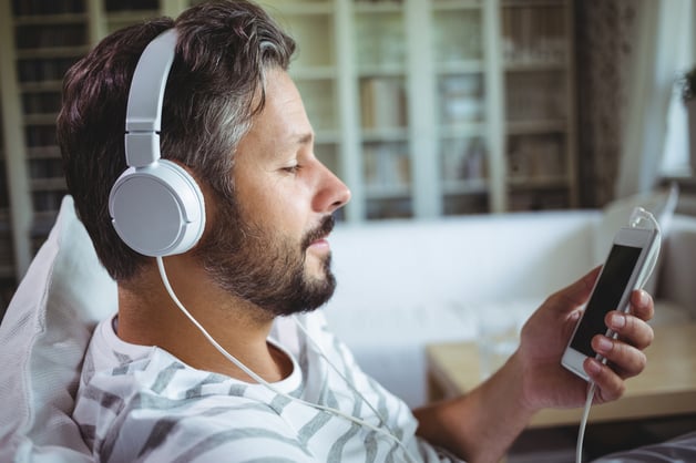 Man listening to music on headphones at home
