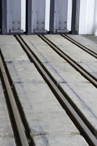 Rails in concrete floor for hangar door at airport