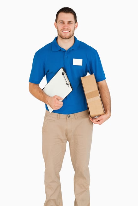 Smiling young salesman with packet and clipboard against a white background