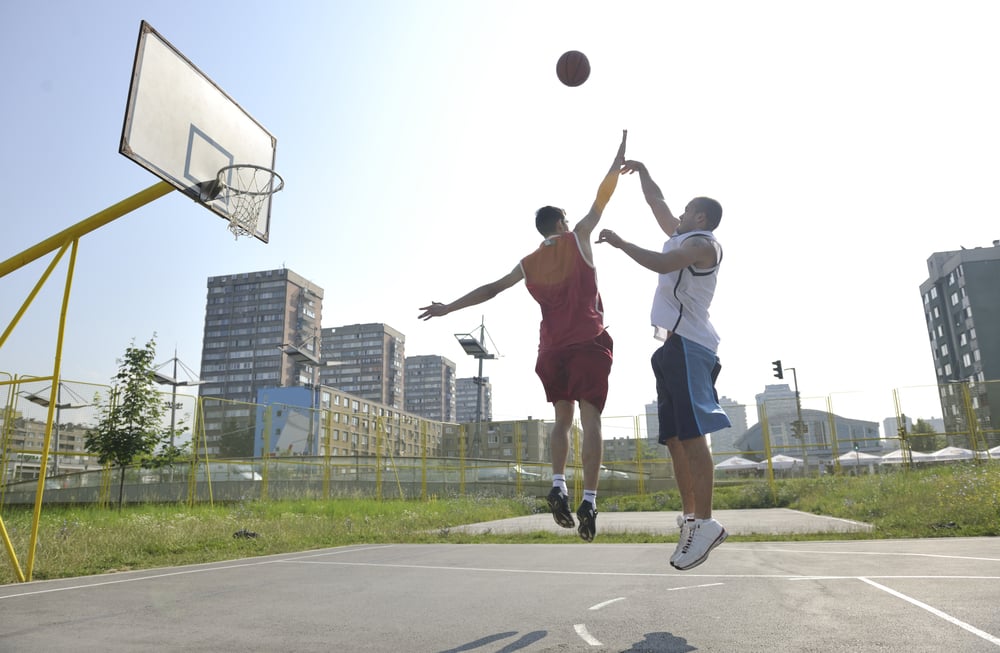 streetball basketball game with two young player at early morning on city court